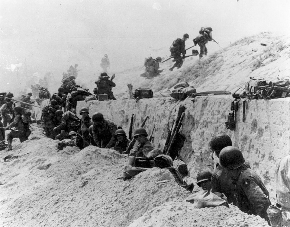 US Soldiers move out over the seawall, Utah Beach Normandy